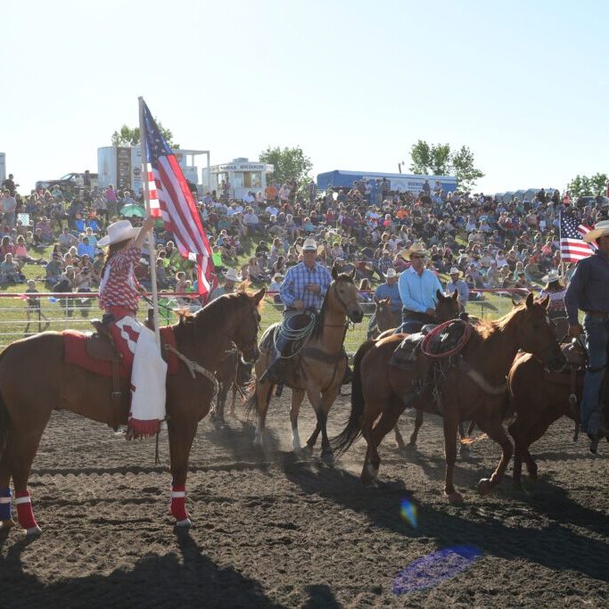 Katelyn Barnes presents America Flag at Hawley, Minn. photo by Gretchen Kirchmann